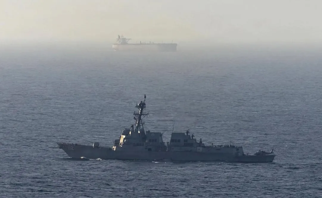 Fotografía tomada de la cuenta en X @CENTCOM del Comando Central de Estados Unidos de un destructor de misiles guiados estadounidense cerca de un buque de carga en el mar Arábigo. El Ejército de EU negó que buques comerciales hayan burlado su bloqueo de los puertos iraníes en el estrecho de Ormuz. Foto: EFE