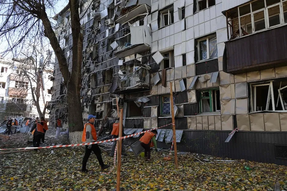 Voluntarios y trabajadores municipales limpian los escombros en una zona residencial afectada por los ataques rusos, en Belgorod. FOTO: AFP